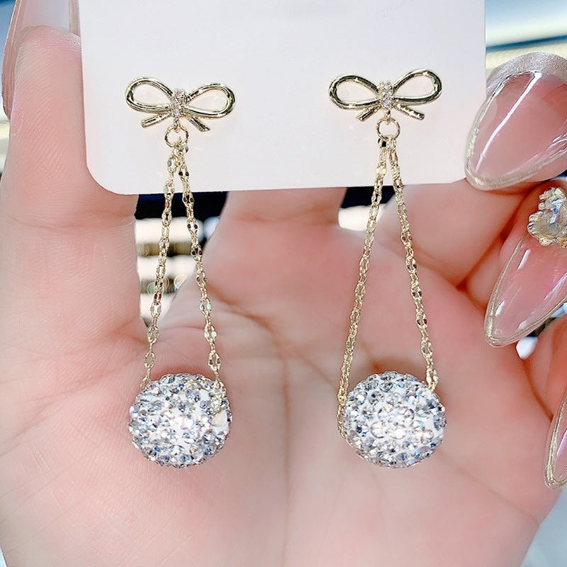 Gold Bow Drop Earrings with Red Stones