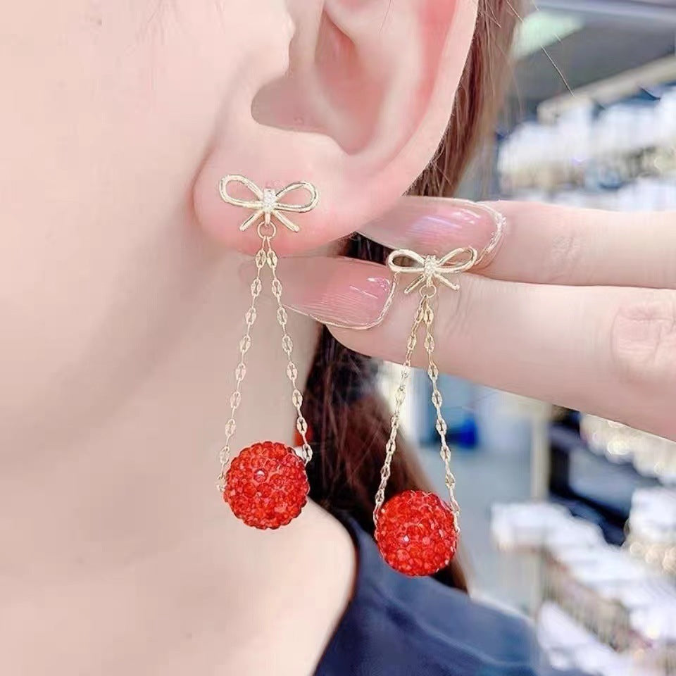Gold Bow Drop Earrings with Red Stones